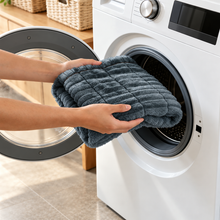 Ironbark RoadDeck Comfort Mat being placed into a front-loading washing machine